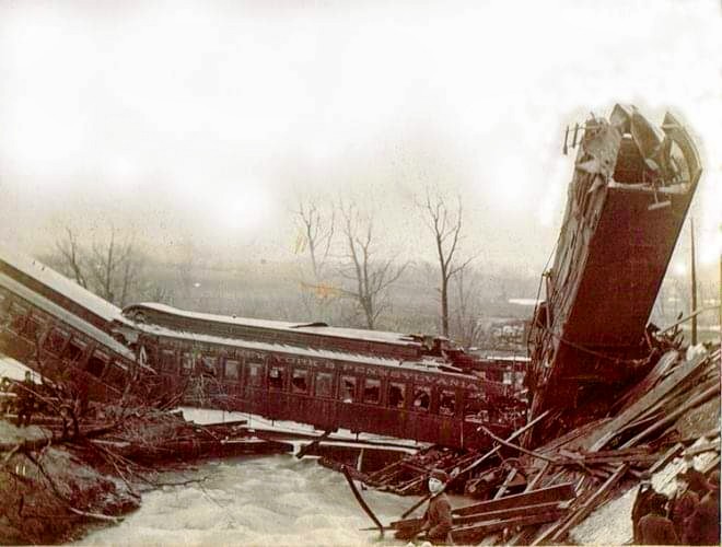 Multiple damaged train cars are strewn about from the accident near Prospect Station